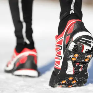 runner dipping shoes in snow