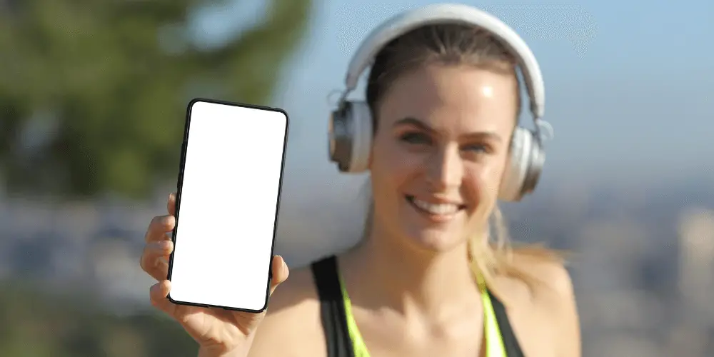 woman running with phone and headphones