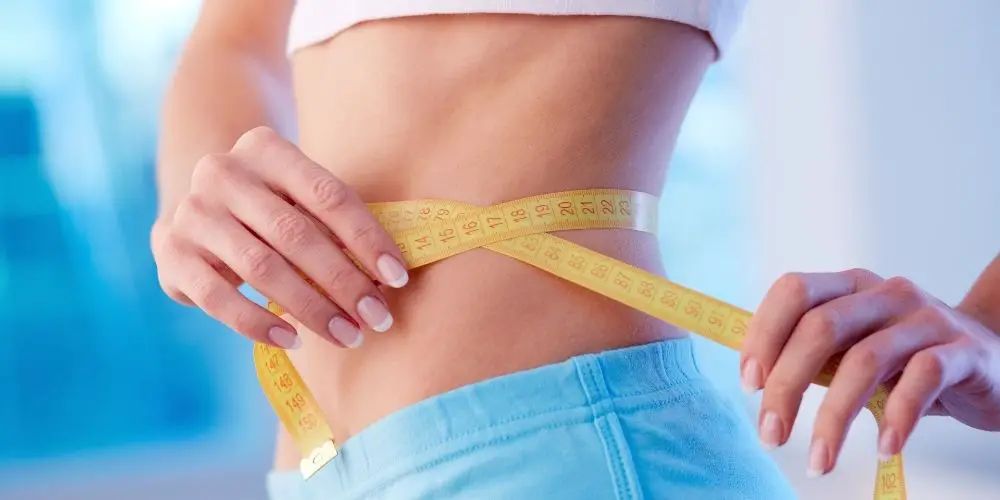 woman measuring stomach